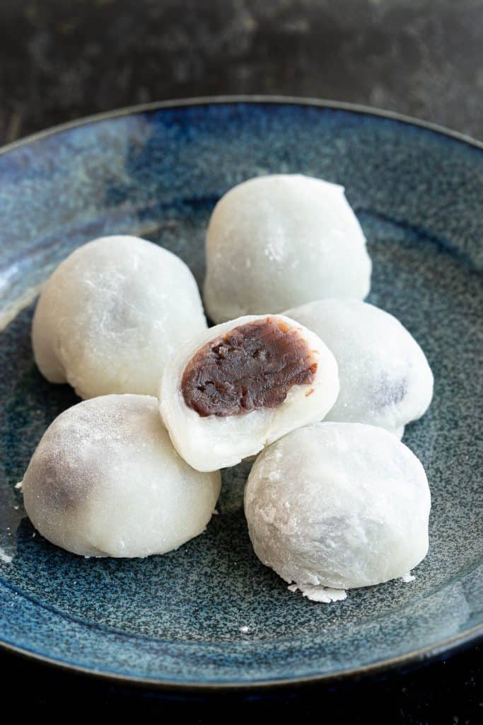 Japanese rice cakes on a blue plate.