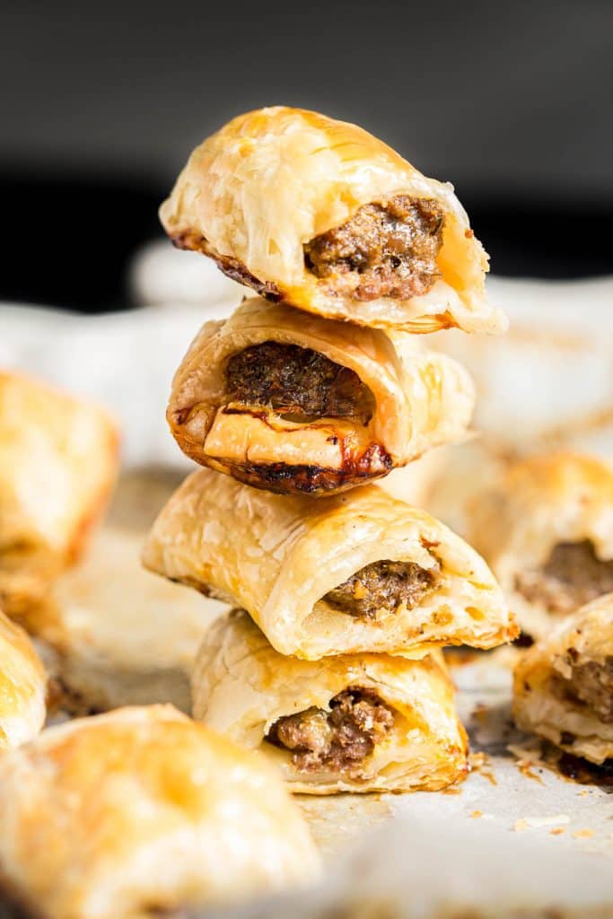 Stack of four beef sausage rolls.