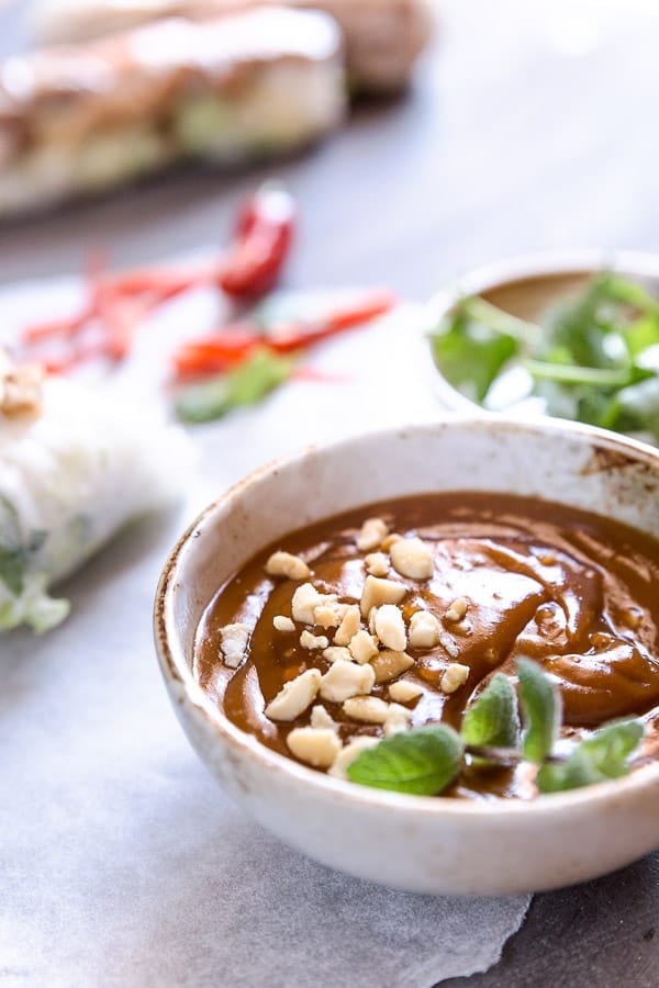Peanut hoisin sauce in a bowl garnished with crushed peanuts