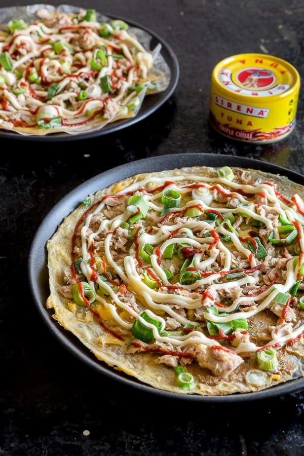 Grilled rice paper pizzas on plates with a can of Sirena tuna in the background.