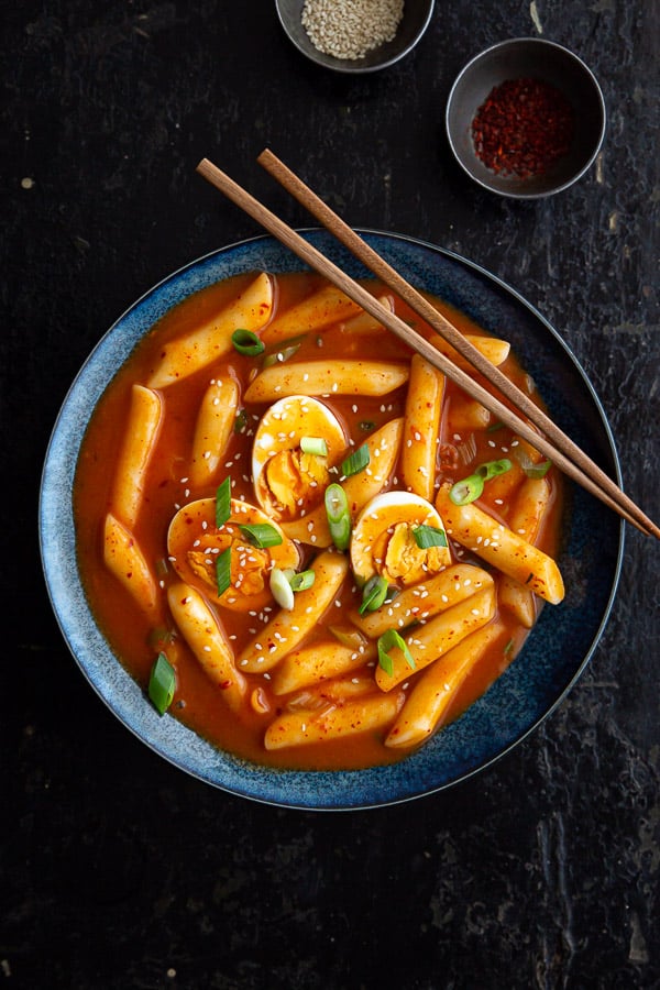 Top down view of tteokbokki showing chewy rice cakes and boiled eggs.