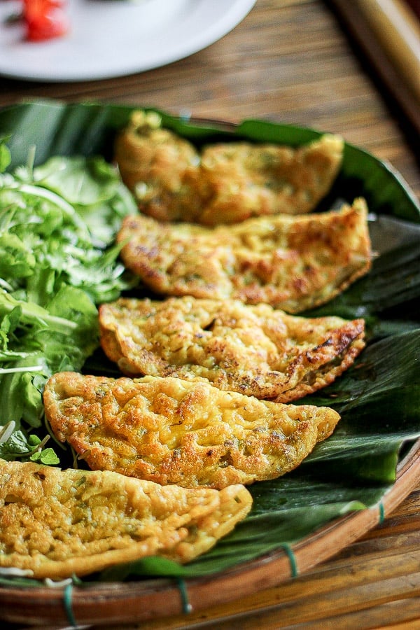 Banh Xeo on weaved plate with banana leaves.
