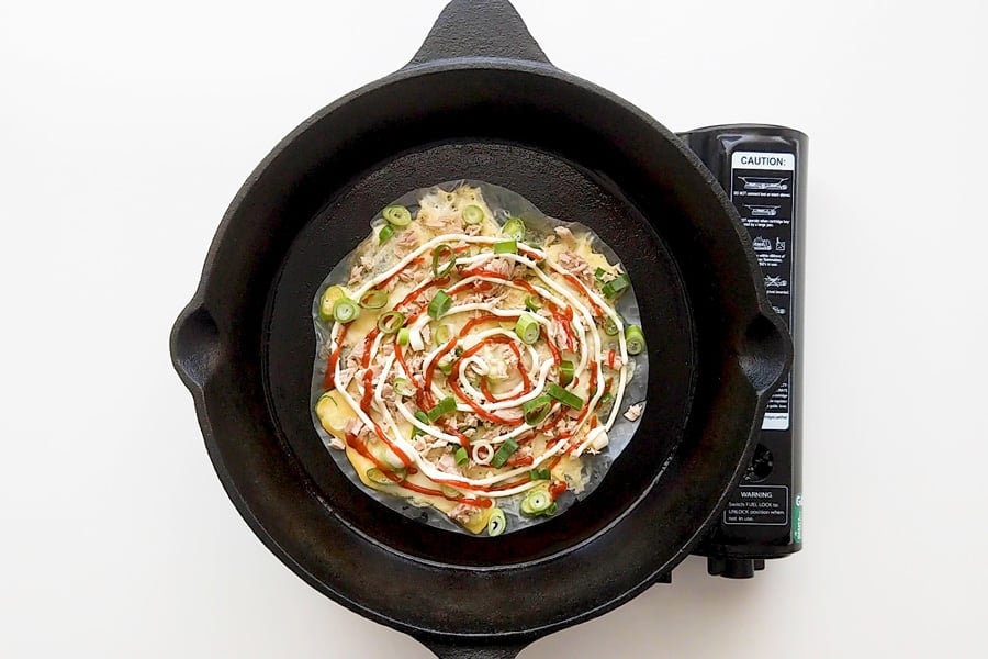 Vietnamese pizza cooking in a cast iron pan.