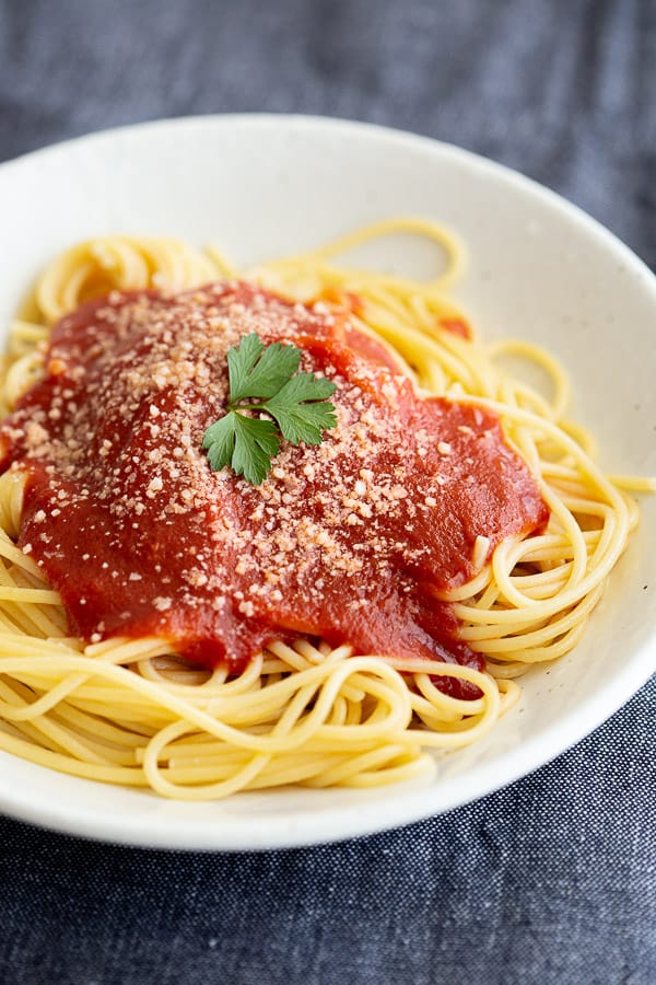 Close up of bowl with spaghetti and tomato based napoli sauce.