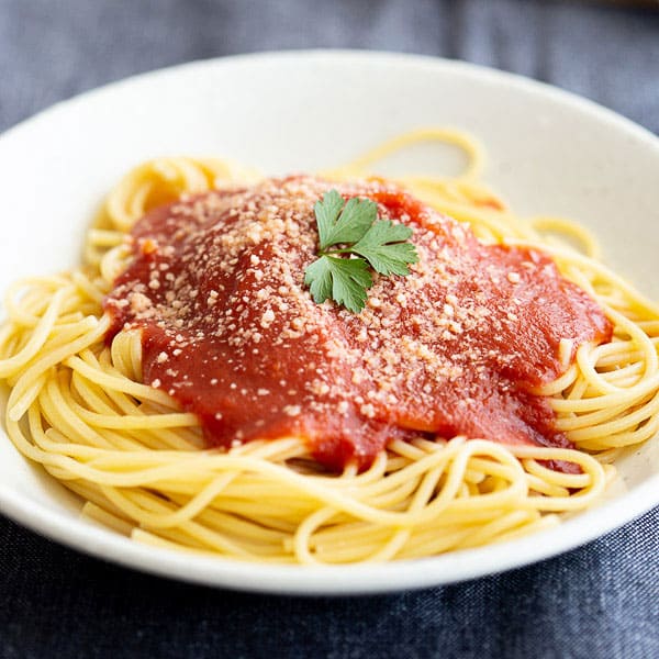 Close up bowl of napoli sauce with pasta.