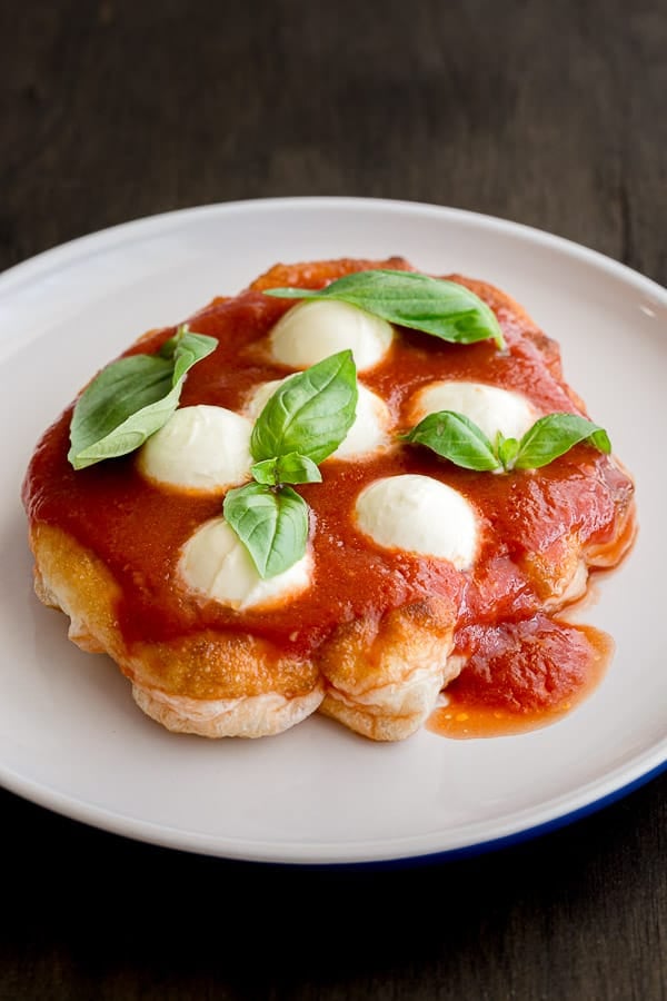 A pizza fritta on a white plate.
