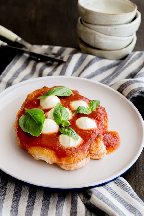 Fresh pizza fritta with tomato sauce topping.