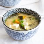 Bowl of Japanese miso soup with pumpkin and tofu.