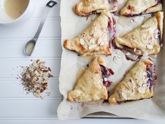 Blueberry turnovers on a baking tray.