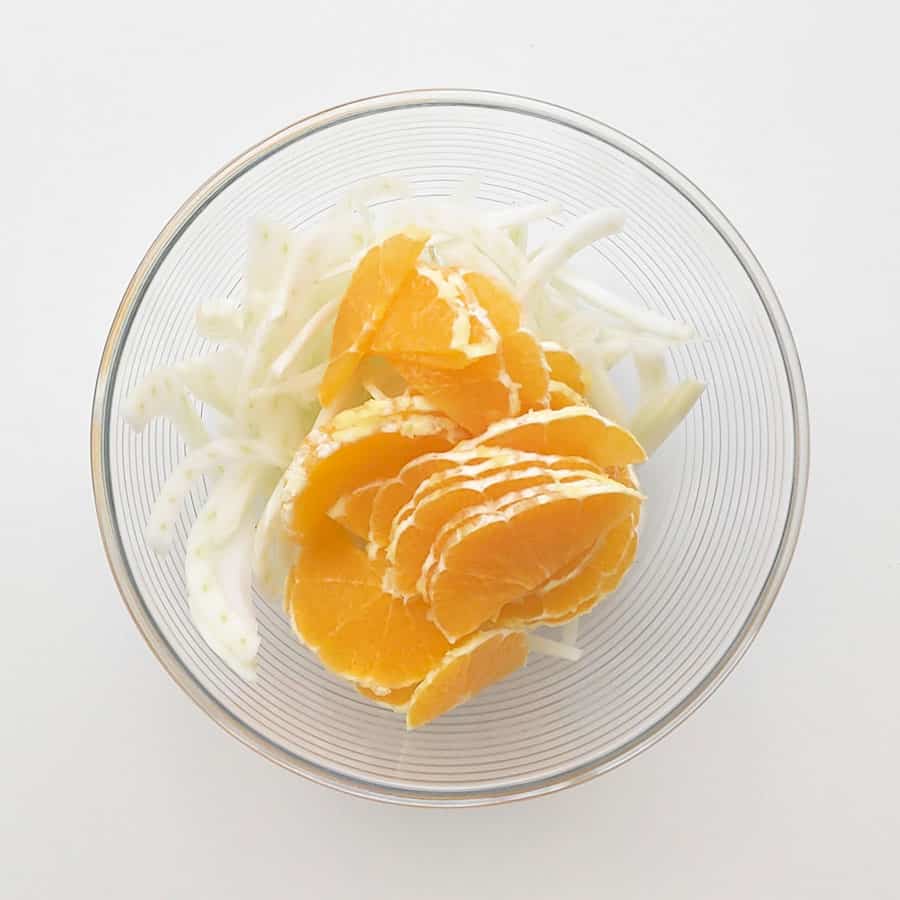Fennel and orange slices in a bowl.