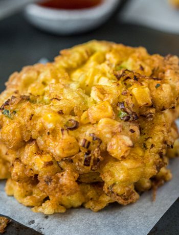 Close up shot of a stack of corn fritters.