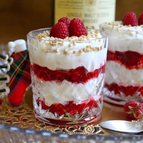 Scottish Cranachan dessert in a glass, showing the layers of stewed berries and whipped cream.