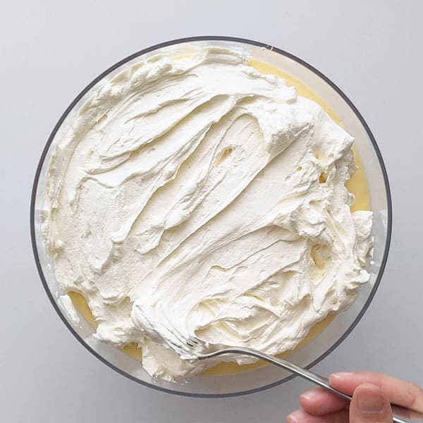 Adding cream layer to trifle.