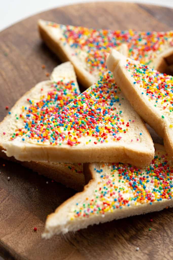 Fairy bread slices stacked on top of each other.