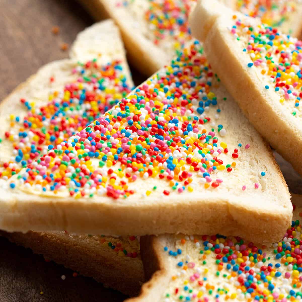 Close up of a slice of fairy bread showing the colourful sprinkles.