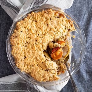 Persimmon crumble in a glass baking dish.