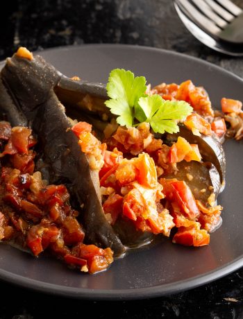 A plate of burmese eggplant stuffed with tomato curry.