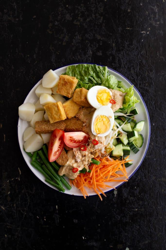 Top view of Indonesian gado gado salad with eggs and vegetables.