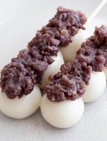 Rice flour dumplings topped with sweet bean paste on a stick.