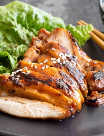 Slices of succulent teriyaki chicken with lettuce and chopsticks.