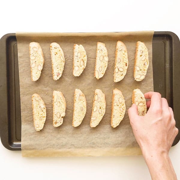 Popping cantucci on baking tray.