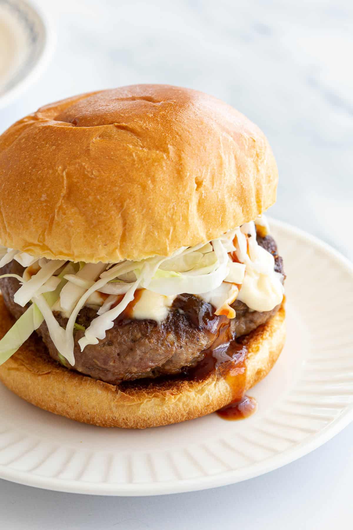 BBQ sauce dripping out of a fresh Japanese style burger.