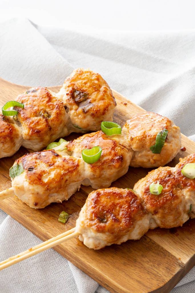 Three skewers with small Japanese style chicken meatballs.