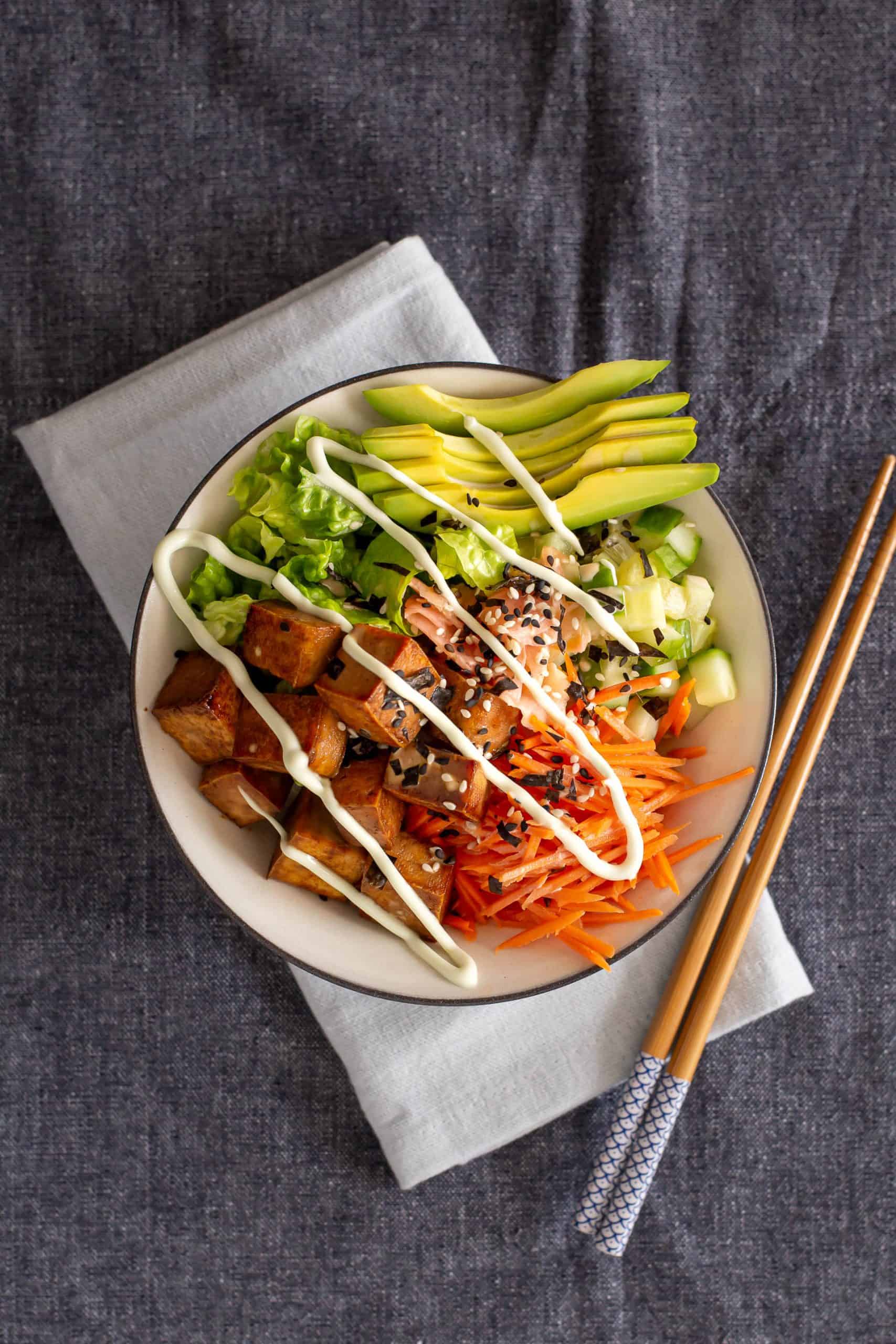 Top down view of a sushi bowl drizzled with sesame mayo.