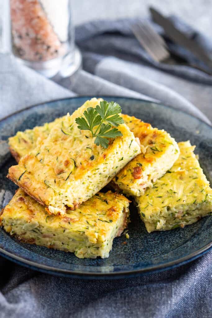 Pieces of zucchini slice on a plate.