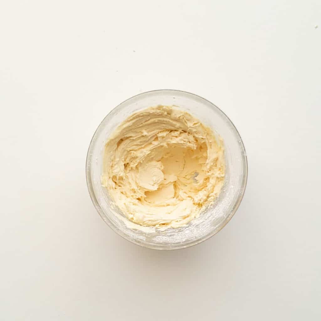 Whipped homemade buttercream in a small bowl.