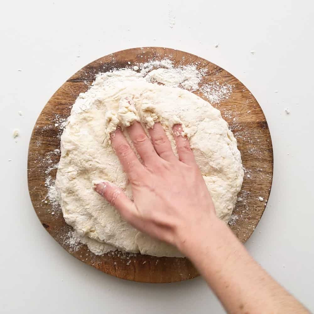 Pressing the scone dough out flat.
