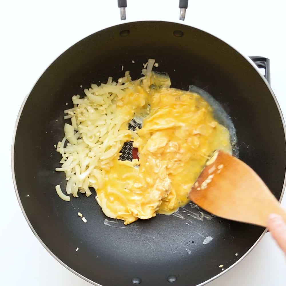 Scrambling eggs in wok.