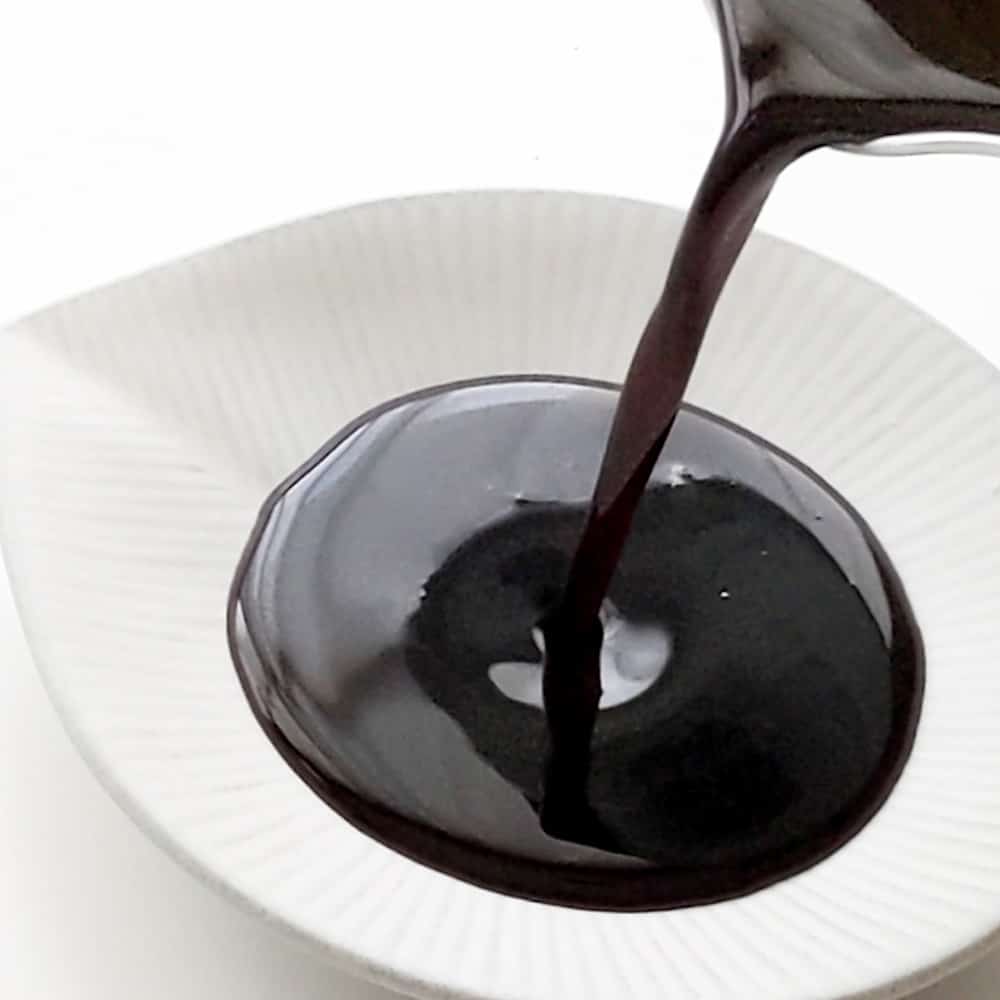 Pouring sweet soy sauce into small dish.