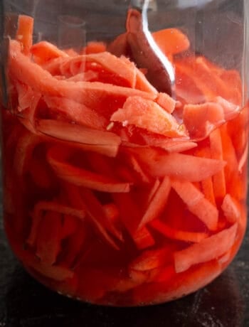 Close up of jar with red pickled ginger.