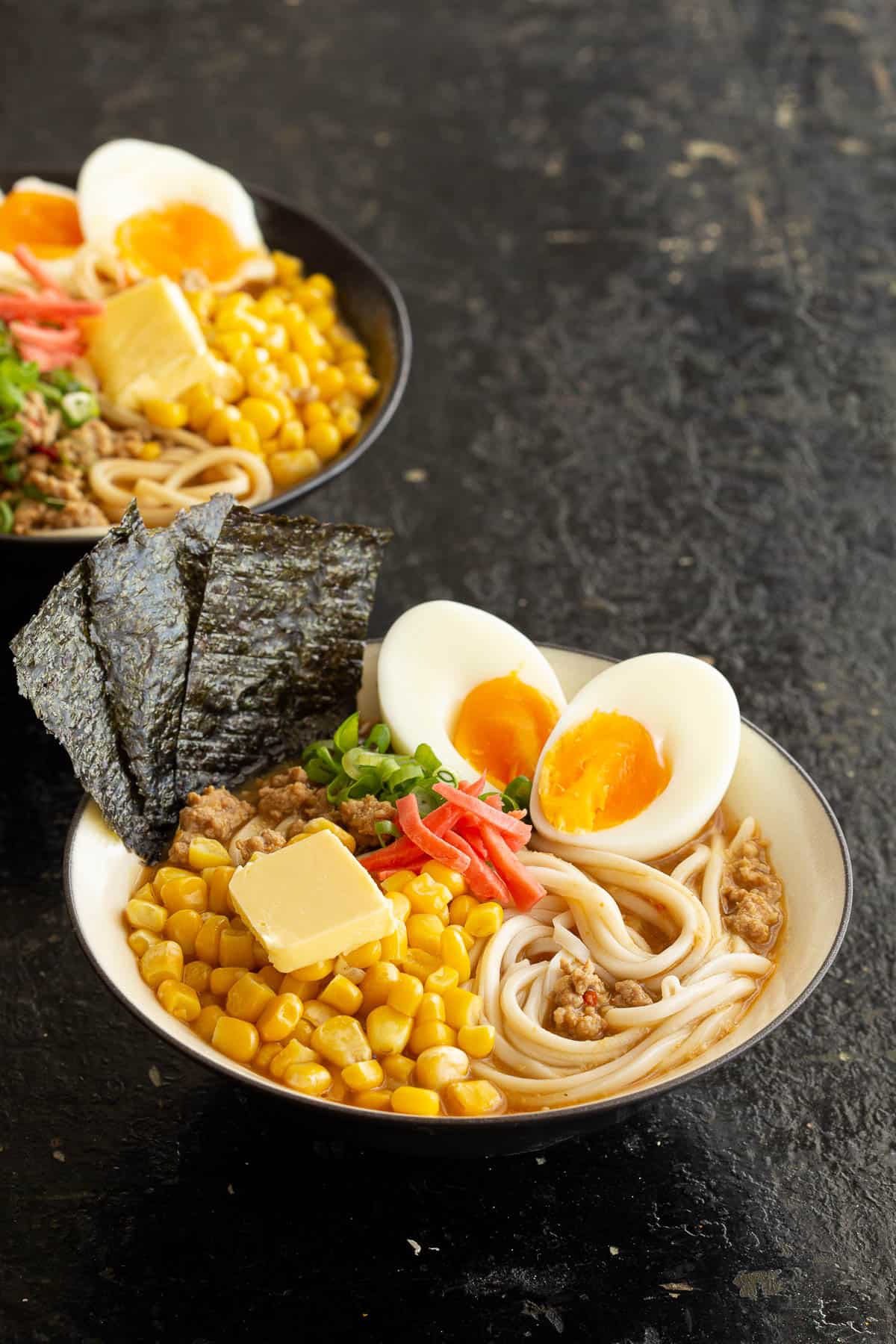 Miso ramen bowls with soft boiled eggs, corn, nori and buttered corn.