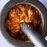 Top view of Panang curry paste in a mortar and pestle.