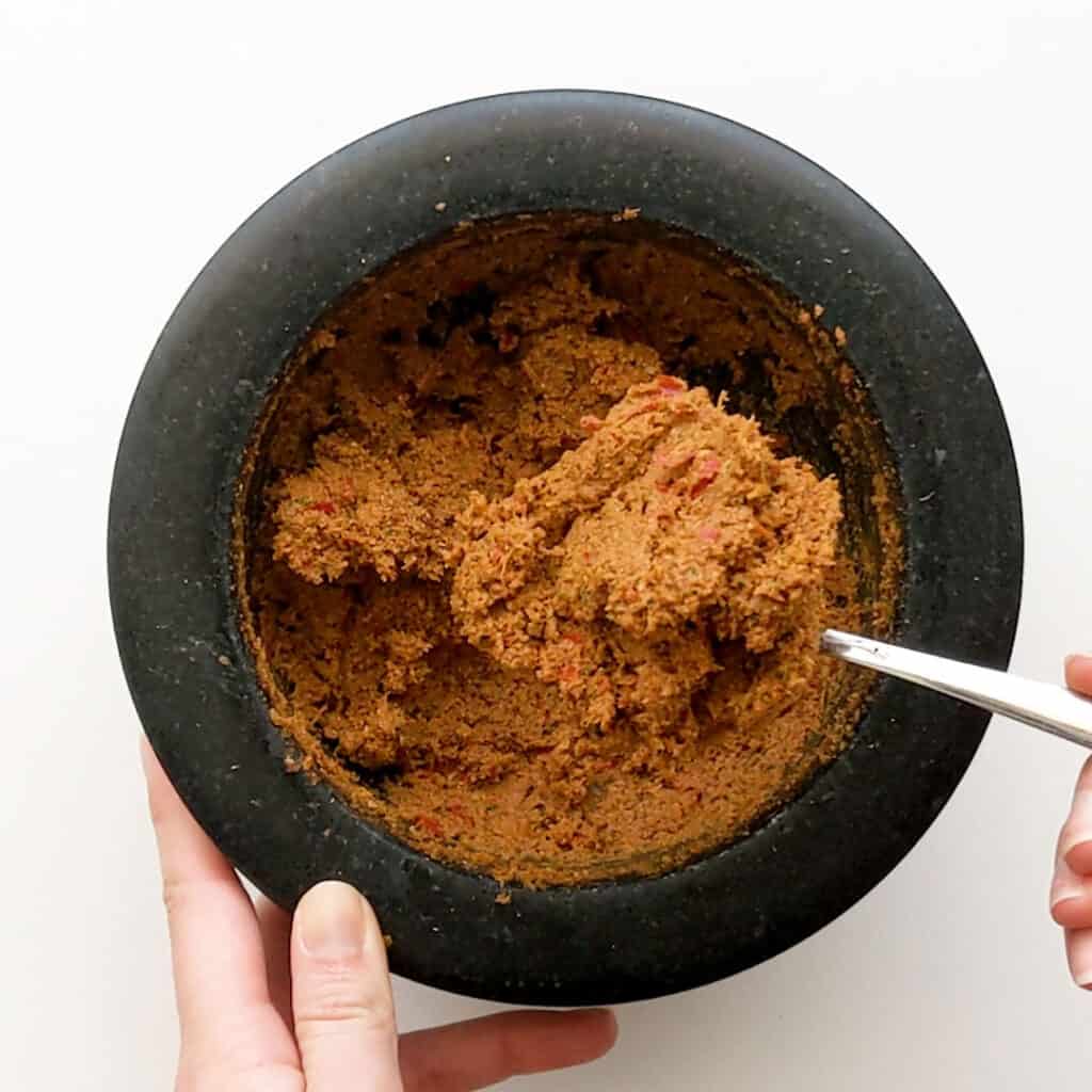 Spoon of curry paste showing the smooth texture.