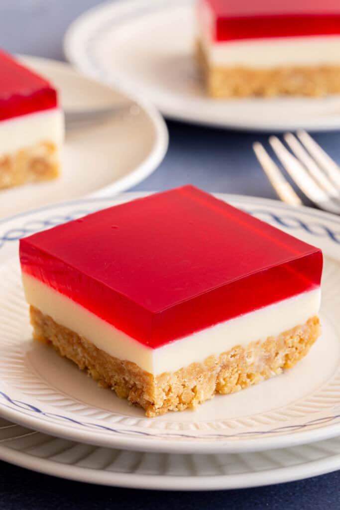 Jelly slice cut into squares with dessert forks.