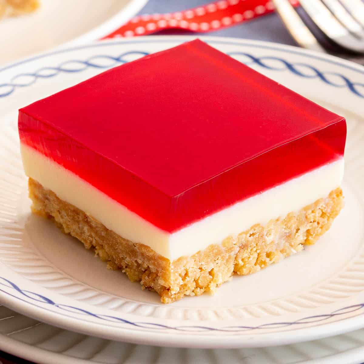 Square piece of jelly slice on a small plate.