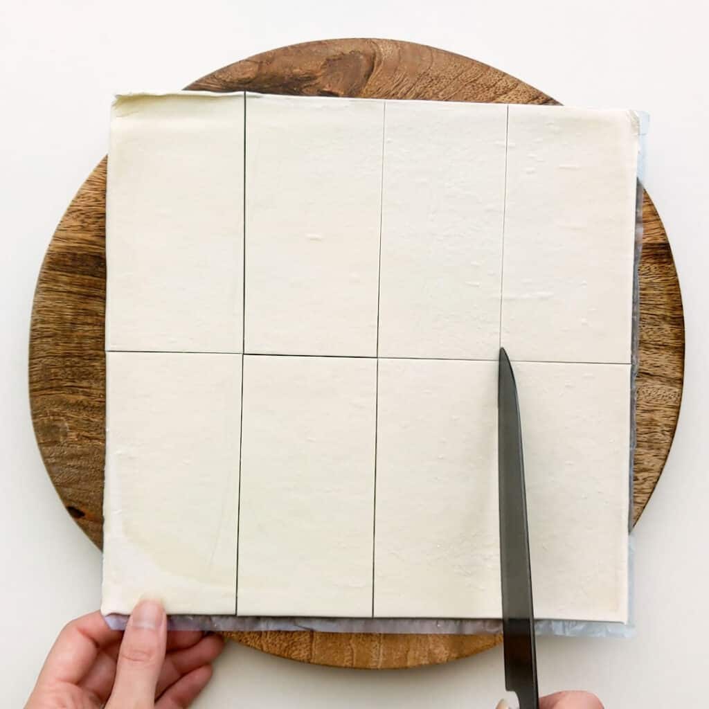 Cutting the puff pastry into rectangles.