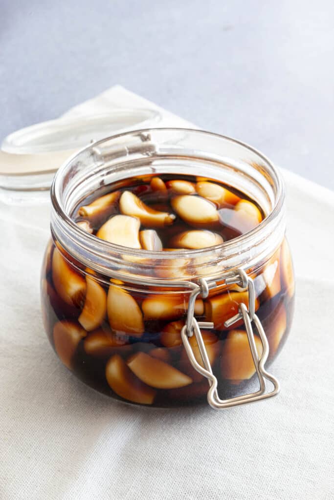 Jar of Korean pickled garlic with the lid open.