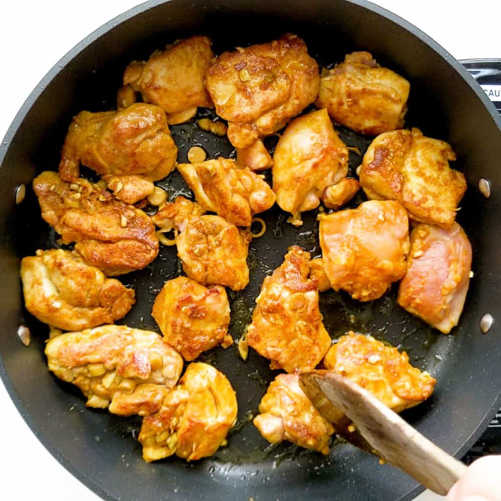 Frying the marinated chicken.