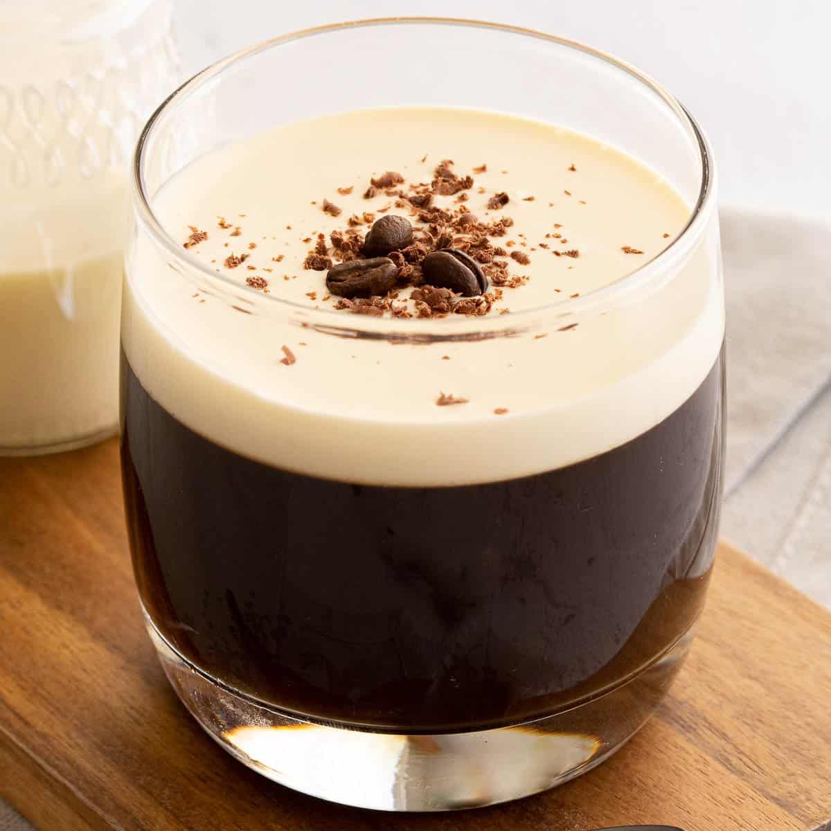 Coffee jelly topped with cream, chocolate and coffee beans.
