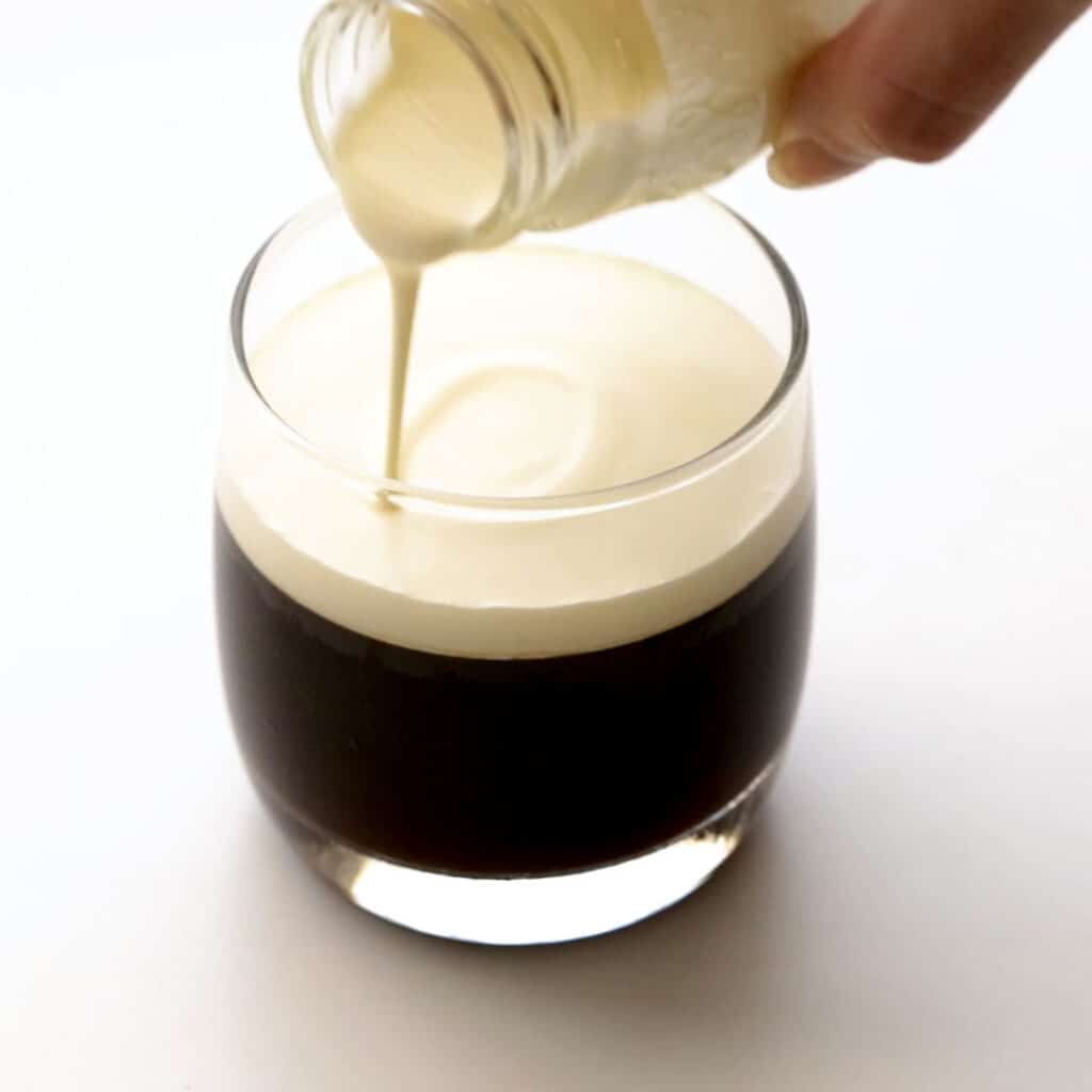 Pouring cream over the coffee jelly.