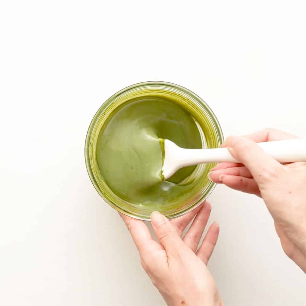 Mixing the matcha and sweetened condensed milk.