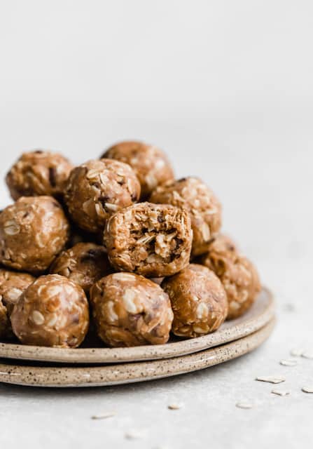 Protein balls on a stack of two plates.