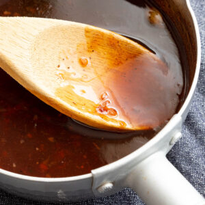 Cooking down Worcestershire sauce in a saucepan.