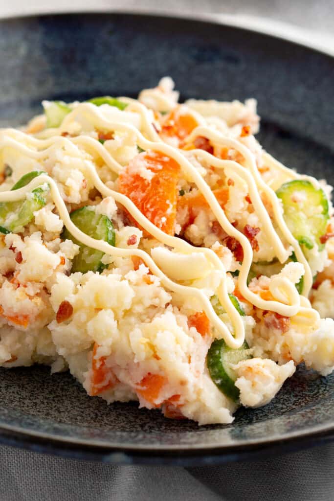Potato salad decorated with lines of kewpie mayonnaise.
