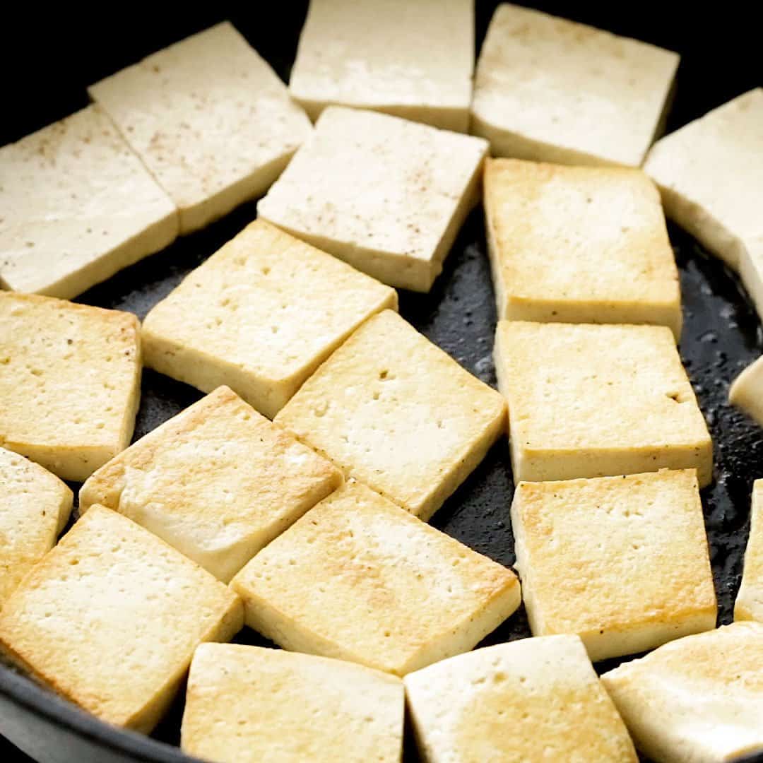 Frying tofu in oil.