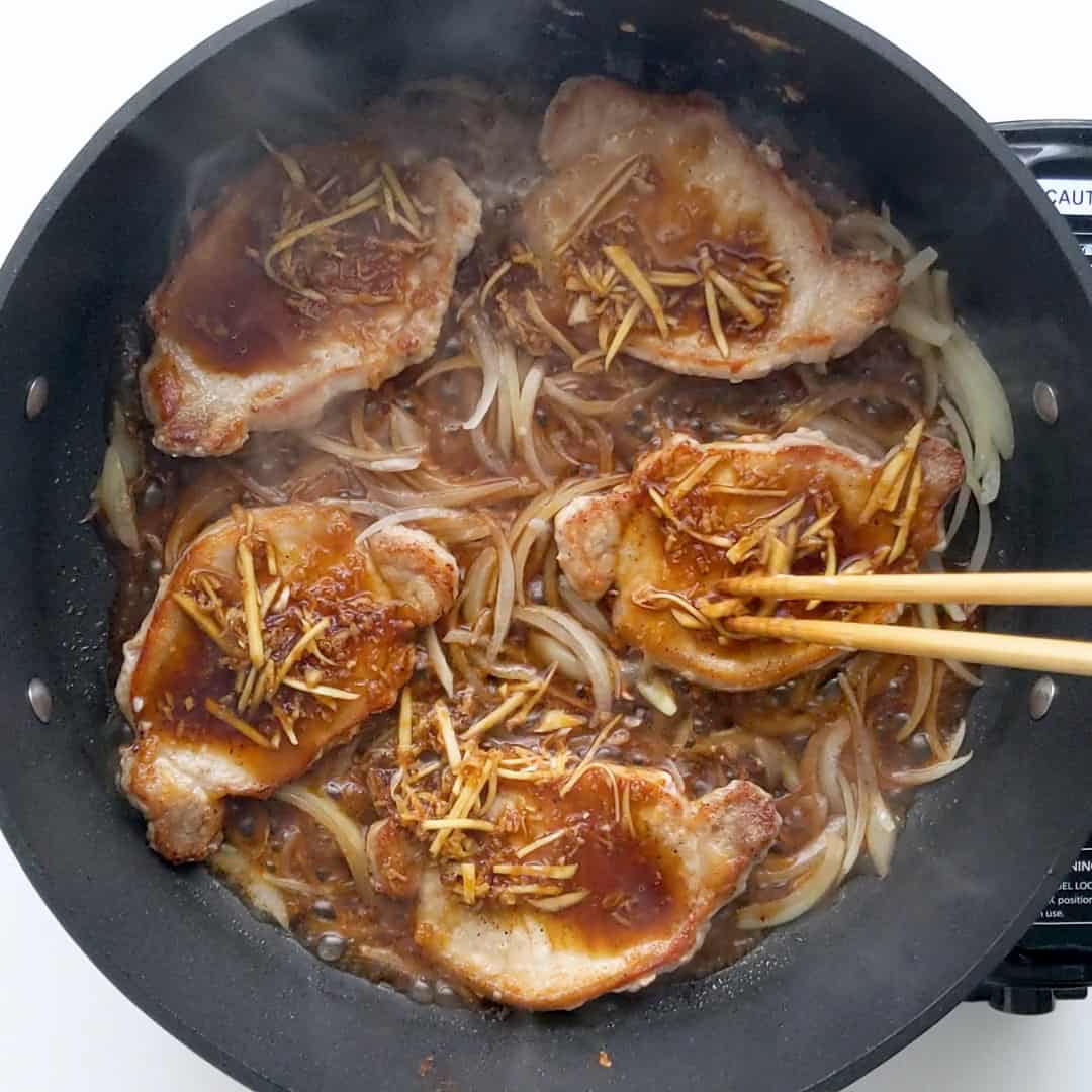 Cooking down the shogayaki pork and onions in the soy and ginger sauce.